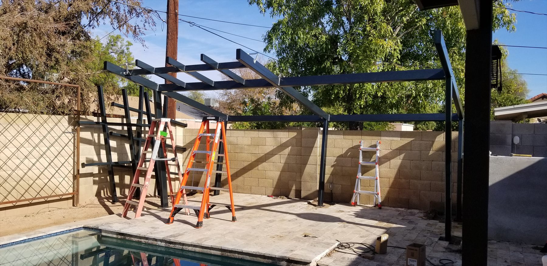 Steel pergola frame being assembled