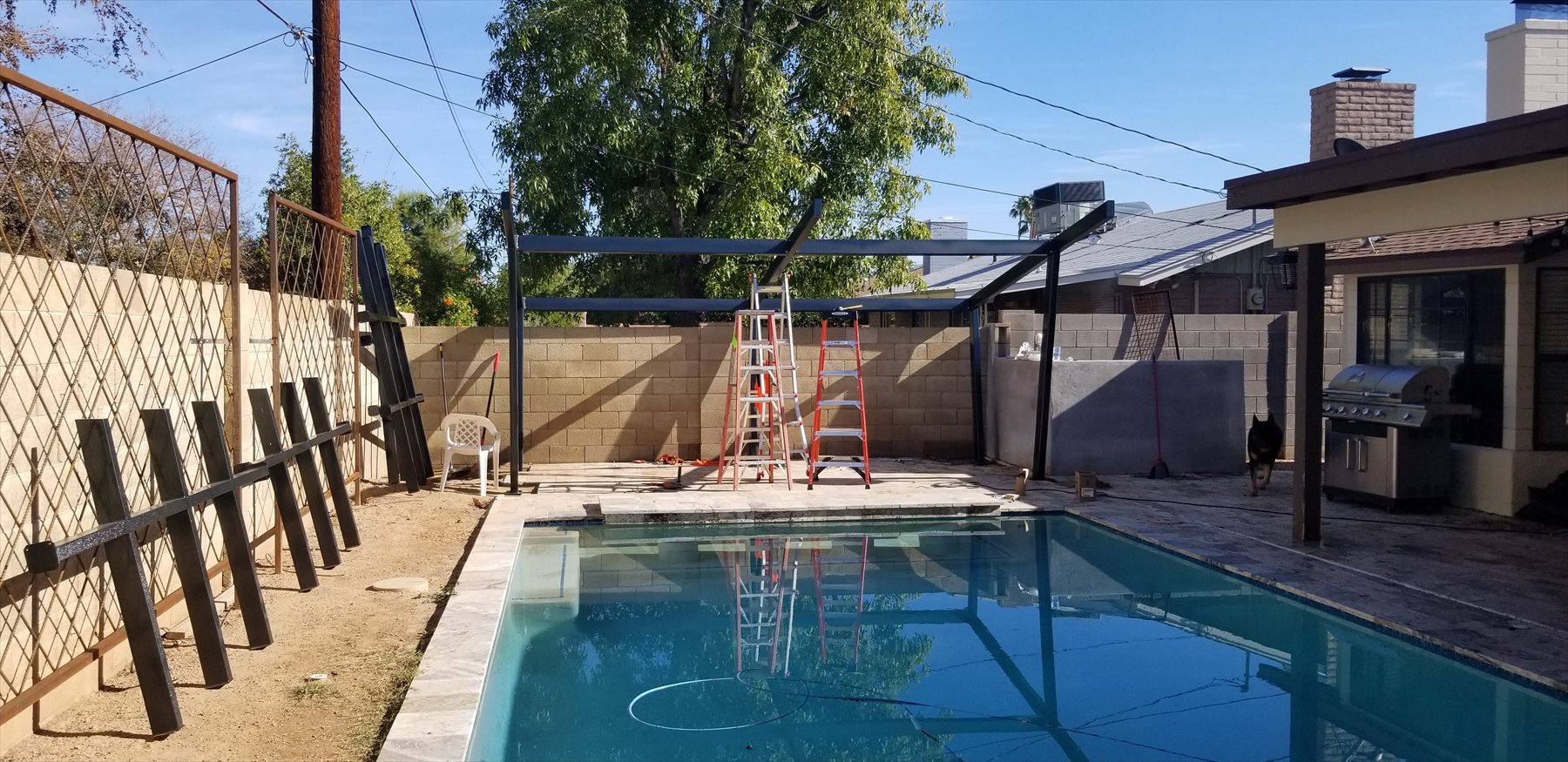 Main pergola beams installed across patio