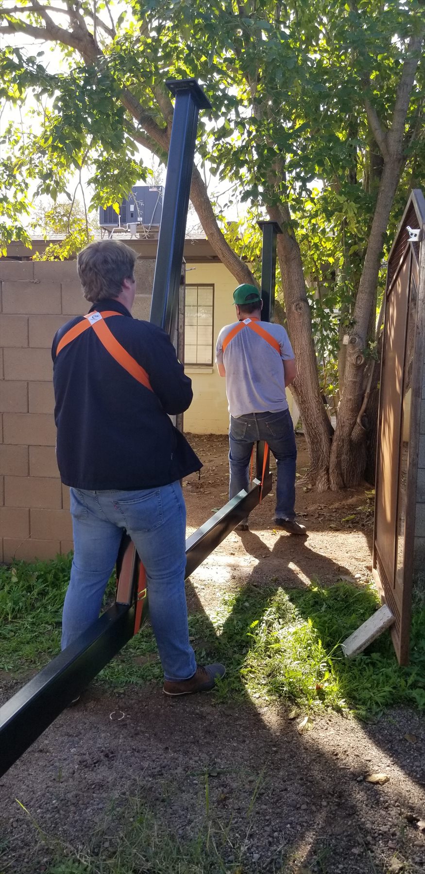 Pergola installation starting near backyard gate